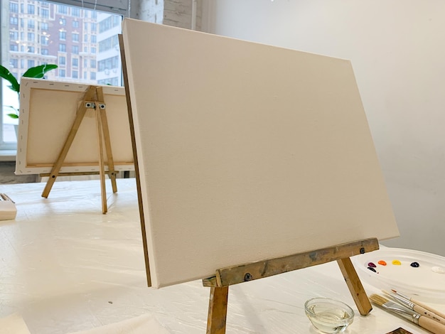 Drawing oil painting on canvas white canvas on the easel set up a painting class artists workplace