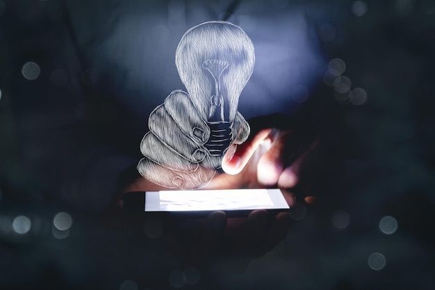 Drawn hand holding a light bulb. a man holding a phone