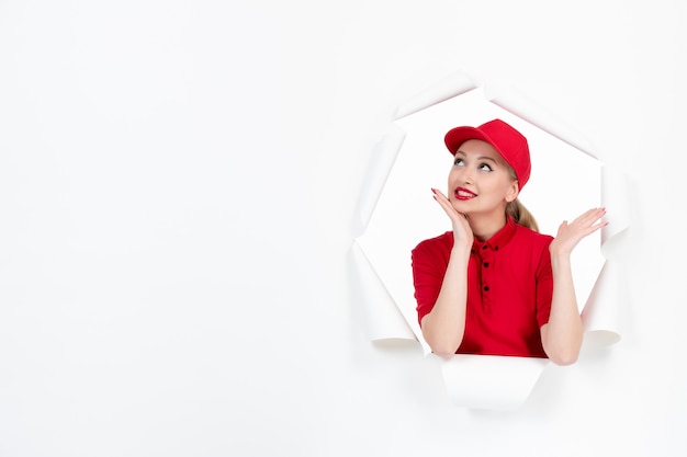 Dreaming female worker in red uniform on white