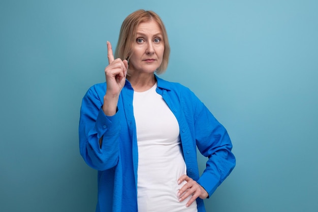 Dreamy blond mature woman with bob haircut on studio background