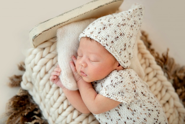 Dreamy newborn baby sleeping on bed