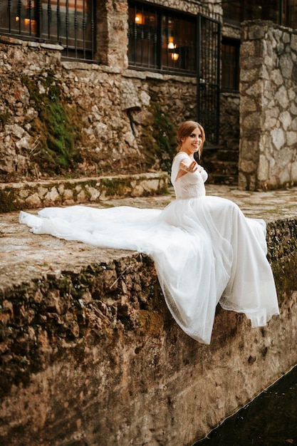 Dreamy portraits of beautiful bride on stone riverbank