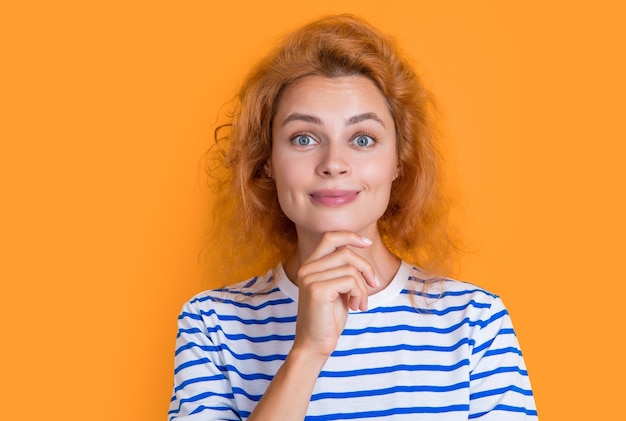 Dreamy redhead girl face isolated on yellow background face of young redhead girl in studio