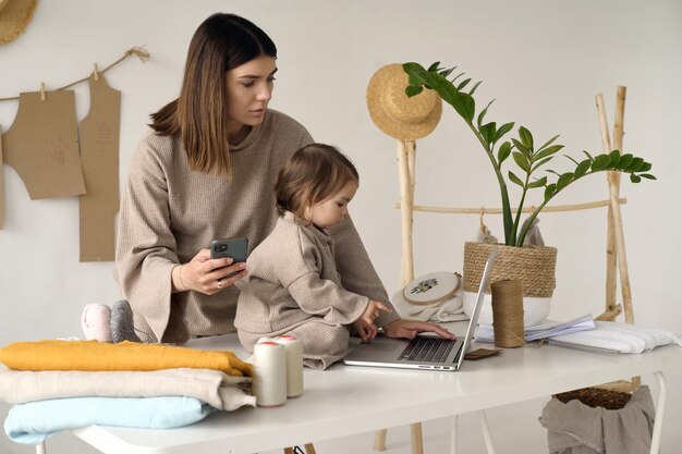 Dressmaker making clothes in her studio with her daughter