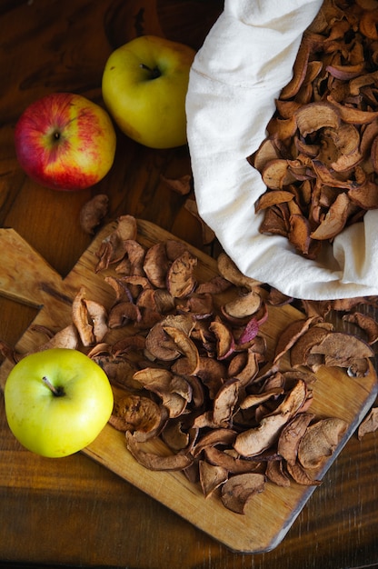 Dried apples on wooden board