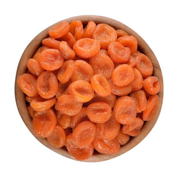 Dried apricots in a wooden bowl on a white background