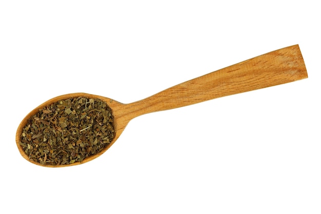 Dried basil seasoning in a wooden spoon