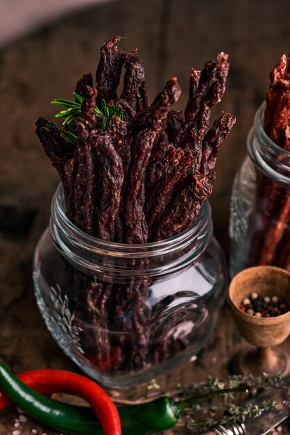 Dried beef and pork meat slices with spices and herbs