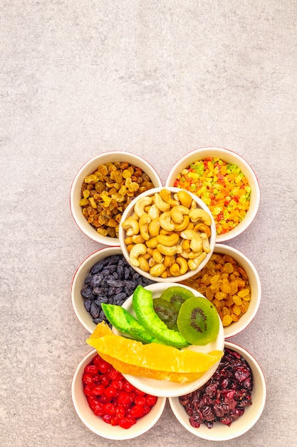 Dried and candied fruit and cashew nuts in ceramic bowls