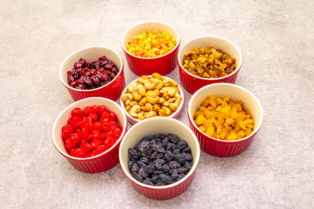 Dried and candied fruit and cashew nuts in ceramic bowls