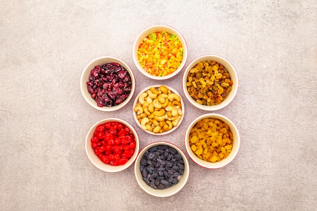 Dried and candied fruit and cashew nuts in ceramic bowls