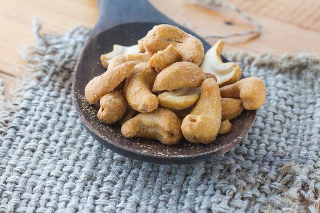 Dried Cashew Nuts on wooden ladle (