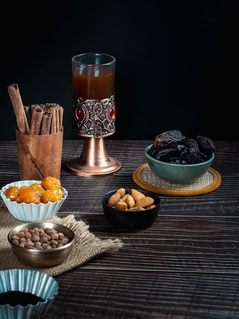 Dried dates fruit and apricot on dark background