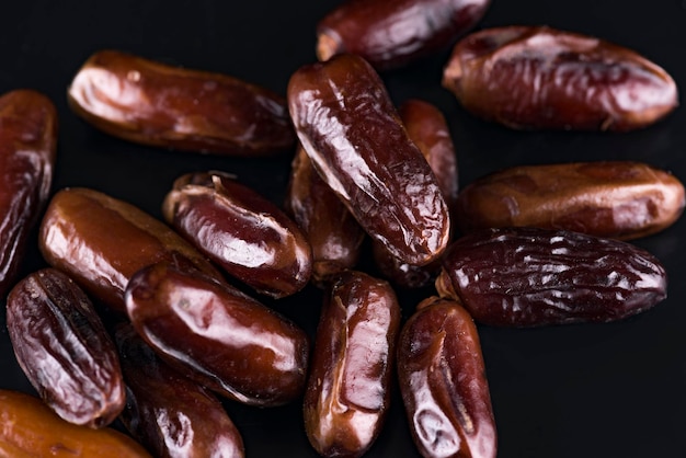 Dried dates, traditional Arabic sweets on a black background