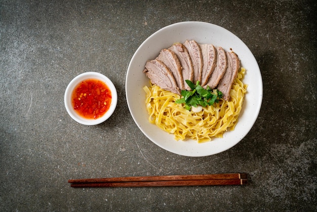 Dried duck noodles in white bowl