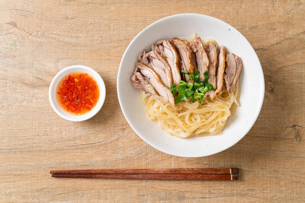 Dried duck noodles in white bowl