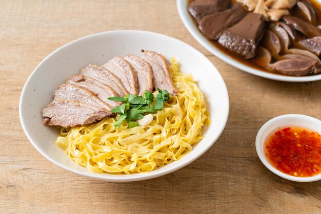 Dried duck noodles in white bowl