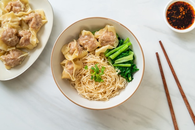 dried egg noodles with pork wonton or pork dumplings without soup Asian food style