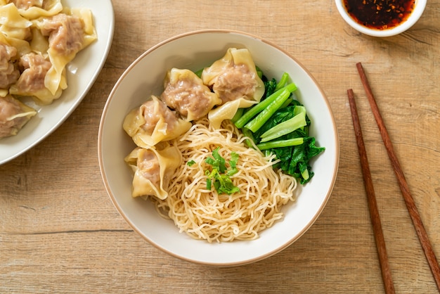 dried egg noodles with pork wonton or pork dumplings without soup Asian food style