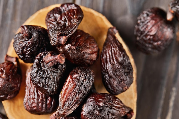 Dried figs on wooden stage and wooden background