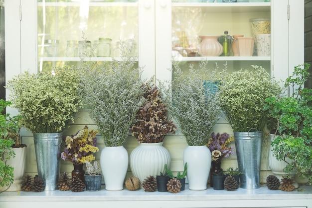 Dried flower in vintage pot and jug ,Decorate in front of cabinet