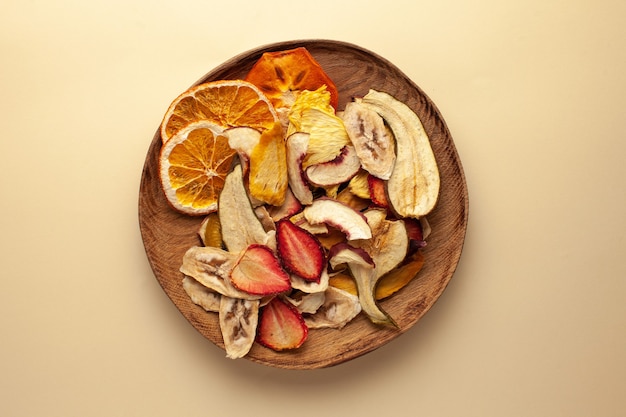 Dried fruit chips on a wooden plate