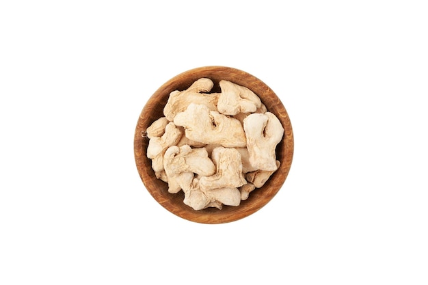 Dried ginger root in wooden bowl on white background top view