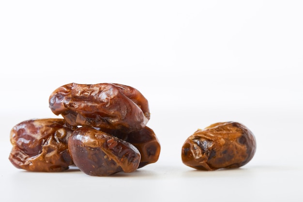 Dried halawi dates on a white