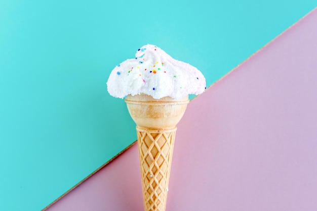 Dried ice cream on pink and green background