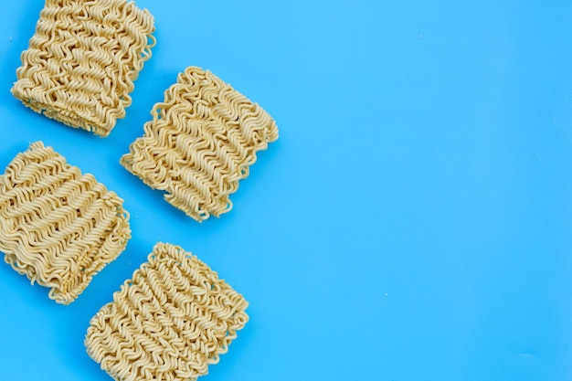 Dried instant noodles on blue background