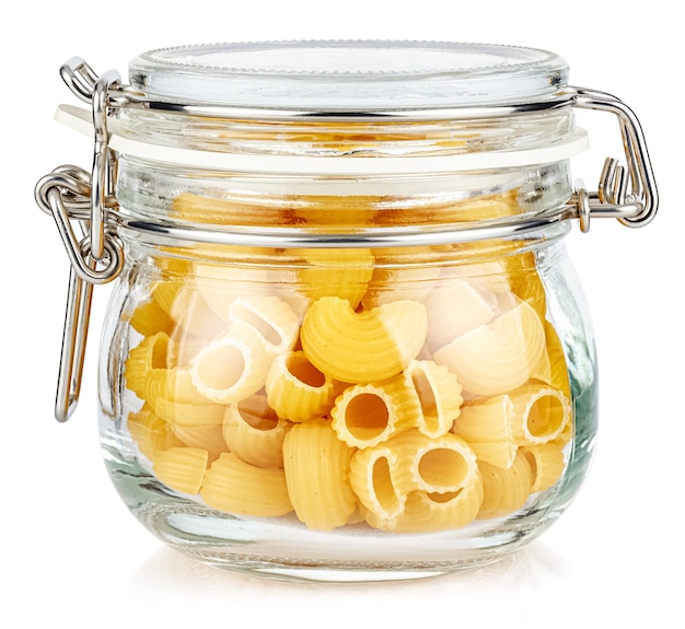 Dried italian pasta snail Pipe rigate in closed transparent glass jar isolated on white