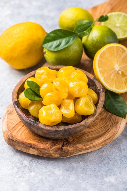 Dried kumquat with orange, lime in bowl