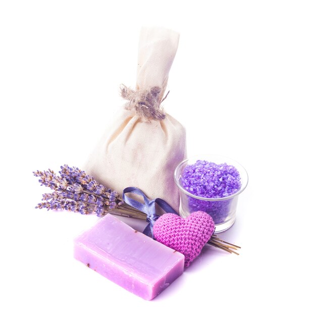 Dried lavender for aromatherpy and spa: soap, sachet, sea salt over white bacgkround