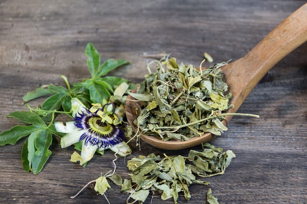 Dried leaves of passiflora to drink sedative tea on wood background