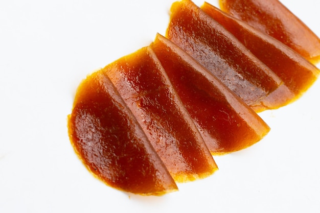 Dried mango paste sheets on white background