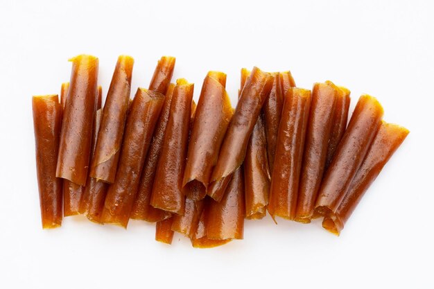 Dried mango paste sheets on white background