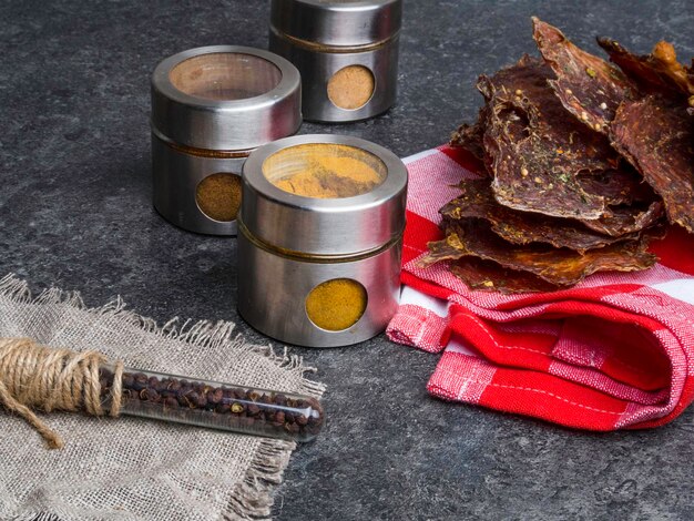 Dried meat pieces dehydrateed slices in spices on the kitchen towel