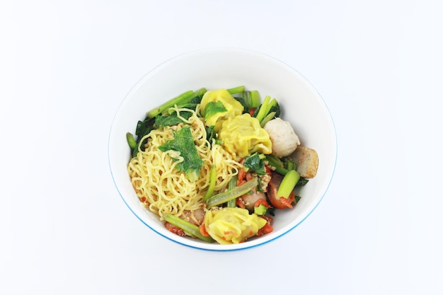 Dried noodles with pork meatball and pork dumplings have vegetable in the bowl asian food favorite