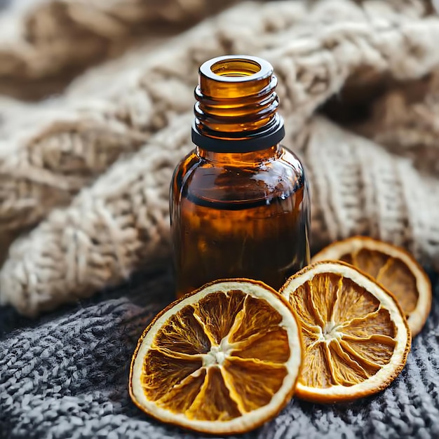 Dried Orange Slices and Amber Bottle of Essential Oil on a Cozy Knit Blanket