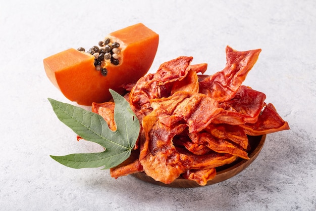 Dried papaya slices on white background close-up.