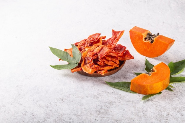 Dried papaya slices on white background.