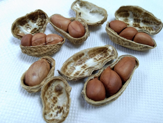 Dried peanuts in closeup. Composition of peanuts serving to make oil, peanut butter. Healthy food.