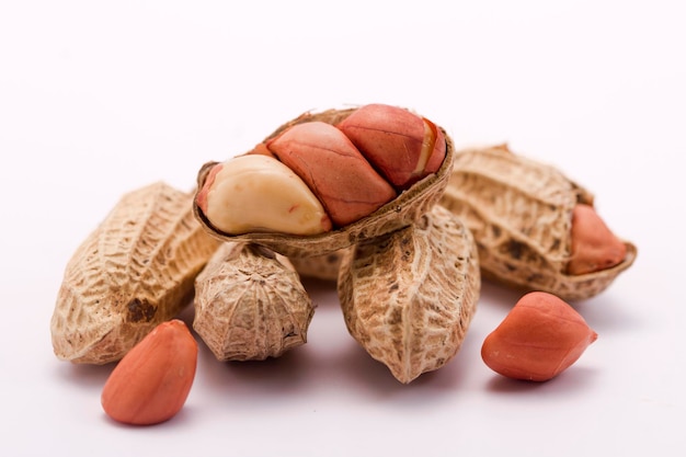 Dried peanuts in closeup on white background