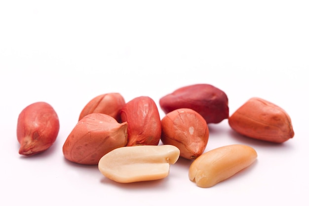 Dried peanuts in closeup on white background