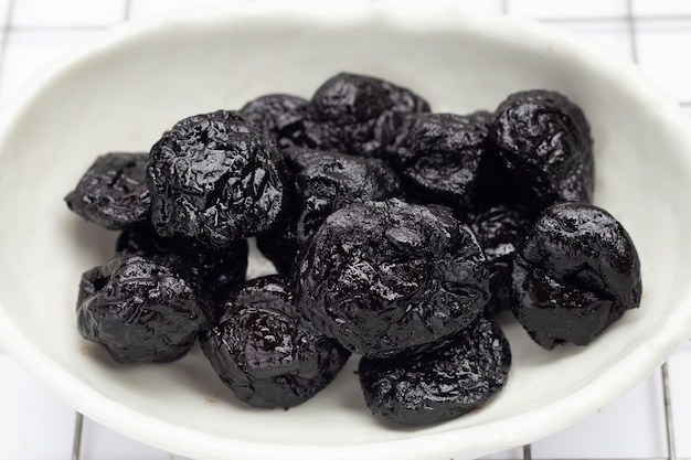 Dried prunes on white background