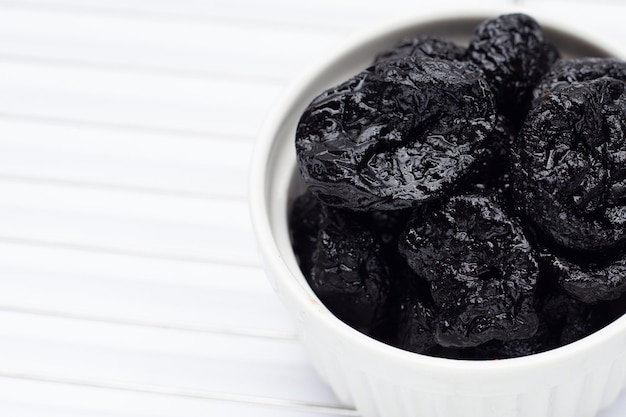 Dried prunes on white background