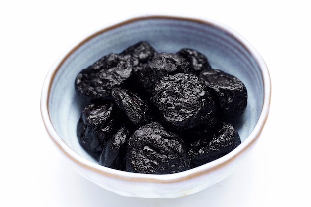 Dried prunes on white background