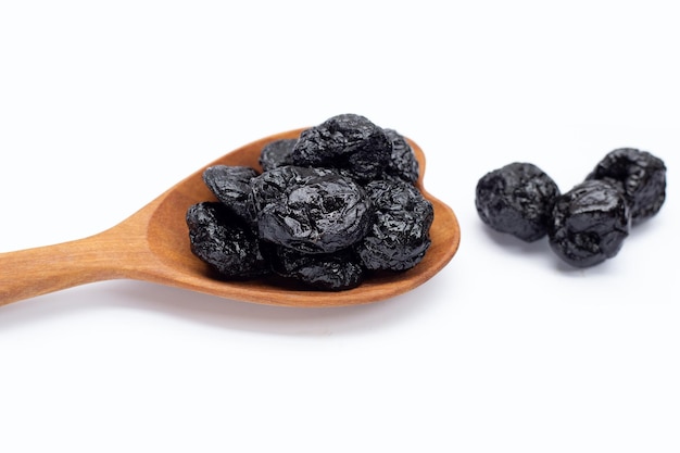 Dried prunes on white background