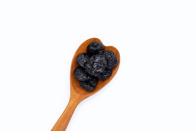 Dried prunes on white background