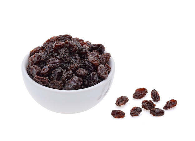 Dried raisins in bowl isolated on white